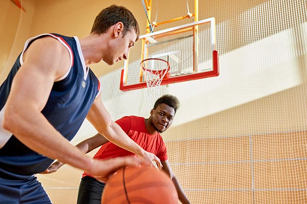 Two men playing basketball